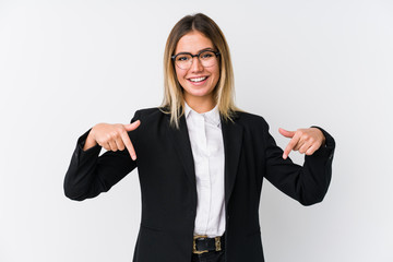 Young business caucasian woman points down with fingers, positive feeling.