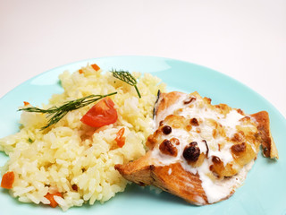 Grilled salmon with white rice on a plate on a white background. fish fillet with rice close up.