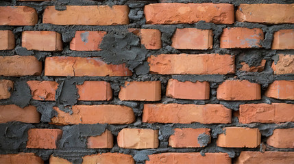 Fototapeta premium New brown brick wall with gray cement. Close up