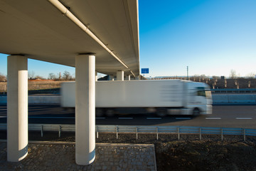 Truck on the new highway under the new bridge.