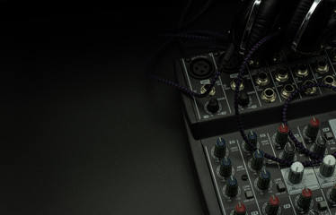 Professional sound and audio mixer control panel with buttons and sliders, cables, audio inputs and outputs isolated on a black background, copy-paste, concept music