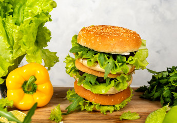 Big burgers with cutlet, cheese and herbs on white background. Close-up.