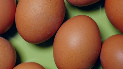 Rotating Brown Eggs On Green Plate Turntable Top View.