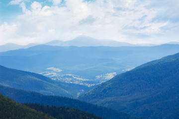 Fototapeta premium Mountain landscape with blue mountains and clouds in the sky_