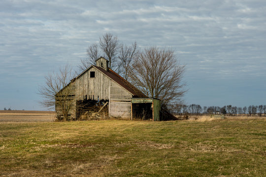An abandoned corn crib or barn with a lean to on the side