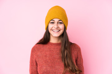 Young caucasian woman wearing a wool cap happy, smiling and cheerful.