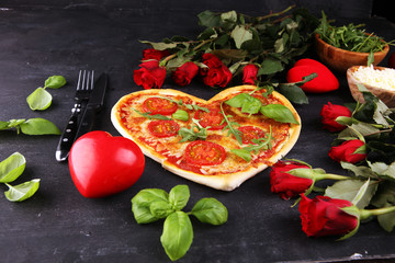 pizza Heart shaped margherita with tomatoes and mozzarella vegetarian. Food concept of romantic love pizza for Valentines Day.