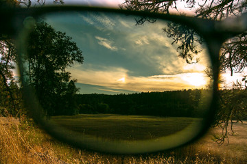 Sunglasses with polarization protection over nature view background
