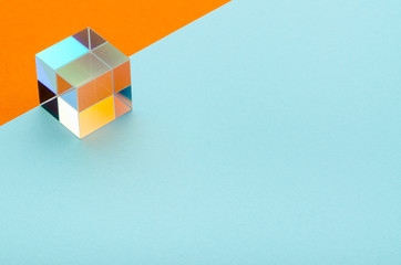 shiny glass cube on a blue-orange background, empty space for text, minimalism, abstraction