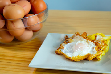 Egg and french fries on a dish