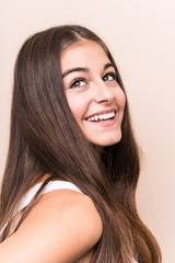 Young cute caucasian woman against a beige background © Asier
