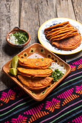 Mexican beef barbacoa tacos on wooden background