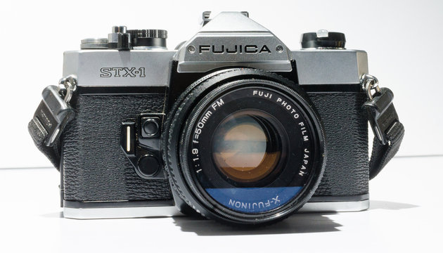 london, england, 05/05/2018 A Retro vintage fujica stx 1 single lens reflex film camera with leather case, and 50mm 1.9 x fujinon lens. vintage hipster camera making a fashionable come back