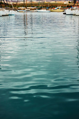 Marina - Water surface with ripple and reflection of yachts