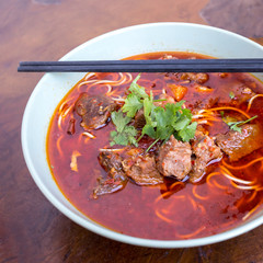 Kung fu noodles like spicy noodle with beef, vegetables and chinese sauce, Chinese traditional...