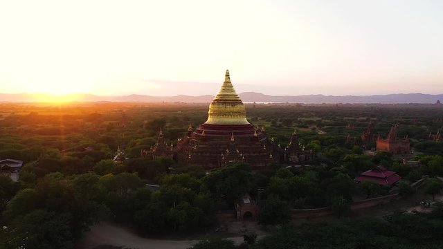 Beautiful golden pagoda, Dhammayazika Pagoda, Pwasaw village, Bagan, Myanmar. aerial panorama of the old temple with direct sunlight during the sunset