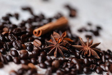 Macro. Roasted coffee beans and spices: anise and cinnamon. Ingredients for spicy traditional local hot drink.