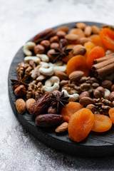 Natural healthy and delicious vegan dessert. Concept of sweet, low calories and tasty snack. Dry fruits and spices. Wooden dark rustic board, neutral background. Close up, macro 