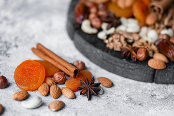 Natural healthy and delicious vegan dessert. Concept of sweet, low calories and tasty snack. Dry fruits and spices. Wooden dark rustic board, neutral background. Close up, macro 