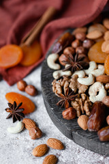 Natural healthy and delicious vegan dessert. Concept of sweet, low calories and tasty snack. Dry fruits and spices. Wooden dark rustic board, neutral background. Close up, macro 