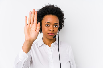Young african american telemarketer woman isolated standing with outstretched hand showing stop...