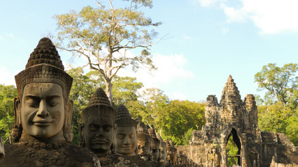 Stone carved faces on the bridge to the Angkor Thom area in Siem Reap, Cambodia