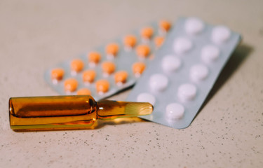 Ampoule with serum, pills and blisters. Pharmaceutical business wallpaper. Medical care. Vitamins...