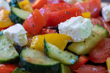 Greek salad with tomatoes and cucumbers close up