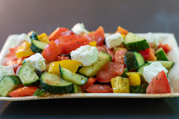 Greek salad with tomatoes and cucumbers close up