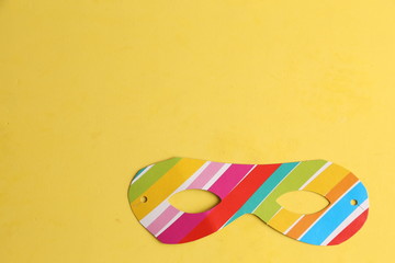 Party cardboard mask on colorful background