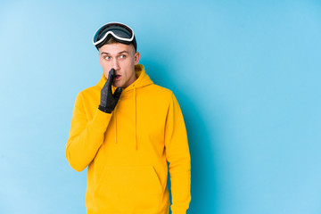Young skier man is saying a secret hot braking news and looking aside