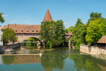 Scenic summer view of the German traditional medieval half-timbered Old Town architecture and Pegnitz river in Nuremberg, Germany