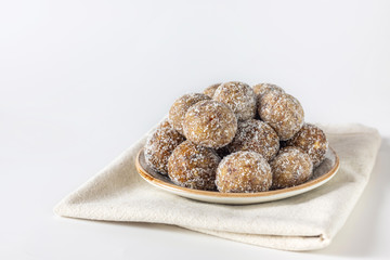 Healthy sweet food. Energy balls in a plate on a white background