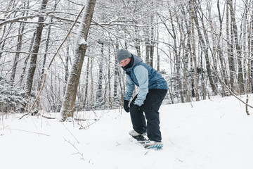 Fototapeta na wymiar Person riding snowskate board in a winter trail