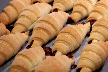 Top view of freshly baked croissants on cutting board