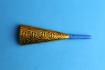 Party cardboard trumpet on colorful background © robcartorres