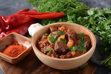 Poached egg with green cucumber, arugula beet leaves , smoked salmon and spices on a toast, wooden background. Healthy French breakfast concept 