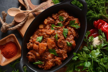 Poached egg with green cucumber, arugula beet leaves , smoked salmon and spices on a toast, wooden background. Healthy French breakfast concept 