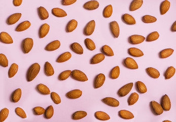 Almonds  in front of the pink background