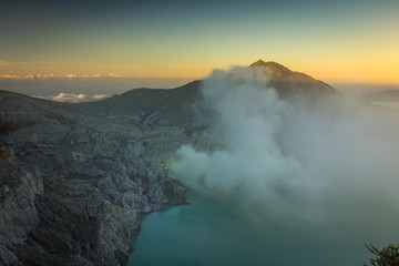 Stunning sunrise or sunset on Ijen Crater. Ijen Crater is a volcanic tourism attraction in Indonesia, located on East Java, famously contains the world’s largest acidic volcanic crater lake.