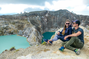 Fototapeta premium Kelimutu - A couple admiring turquoise coloured volcanic lakes