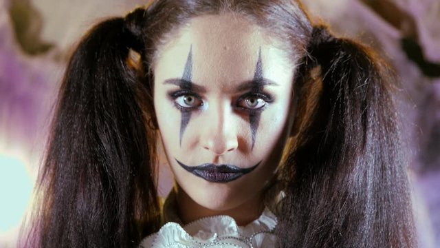 Portrait of a woman. A clown with a smile in corset with a white collar on the neck. Model with makeup for Halloween.