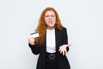 red head young woman looking angry, annoyed and frustrated screaming wtf or what‚Äôs wrong with...