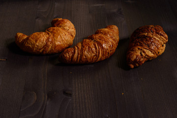 tasty butter croissants on wooden background
