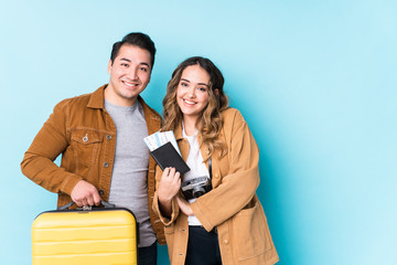 Young couple ready for a travel isolated laughing and having fun.