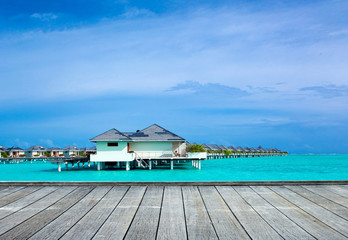 tropical beach in Maldives with few palm trees and blue lagoon