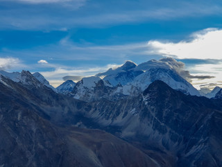 Obraz na płótnie Canvas Everest and Nuptse in clouds. Picturesque mountain view from Gokyo Ri at sunrise. Trekking in Solokhumbu, Nepal, Himalayas.