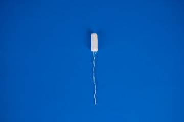 women's health and medicine - tampons on a blue background