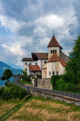Thunderstorm clouds over the Parish Church of St. Peter in Tirol, South Tyrol. Italy.