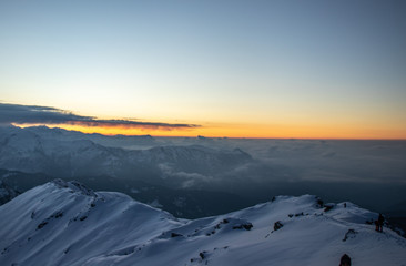 A beautiful view of a sunrise and himalayan mountains from the summit of a himalayan mountain